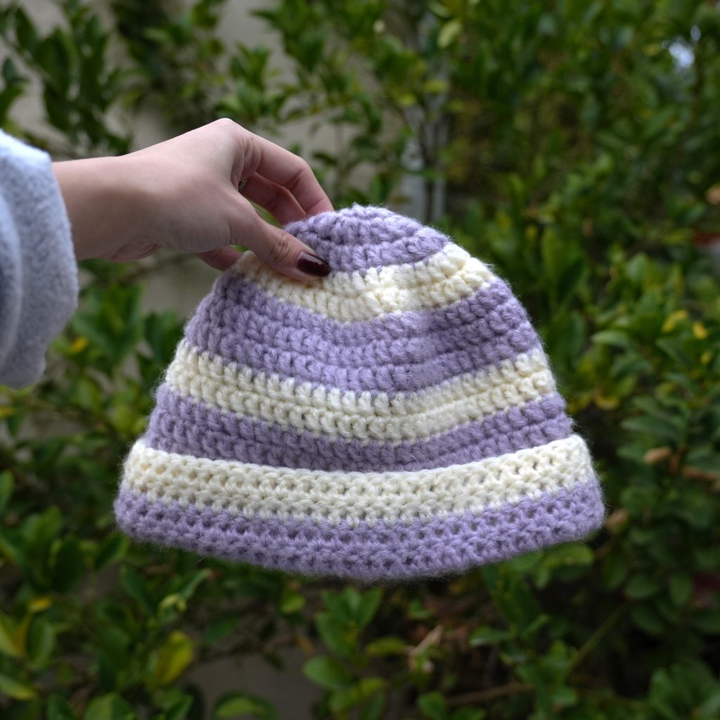 striped crochet beanie held up